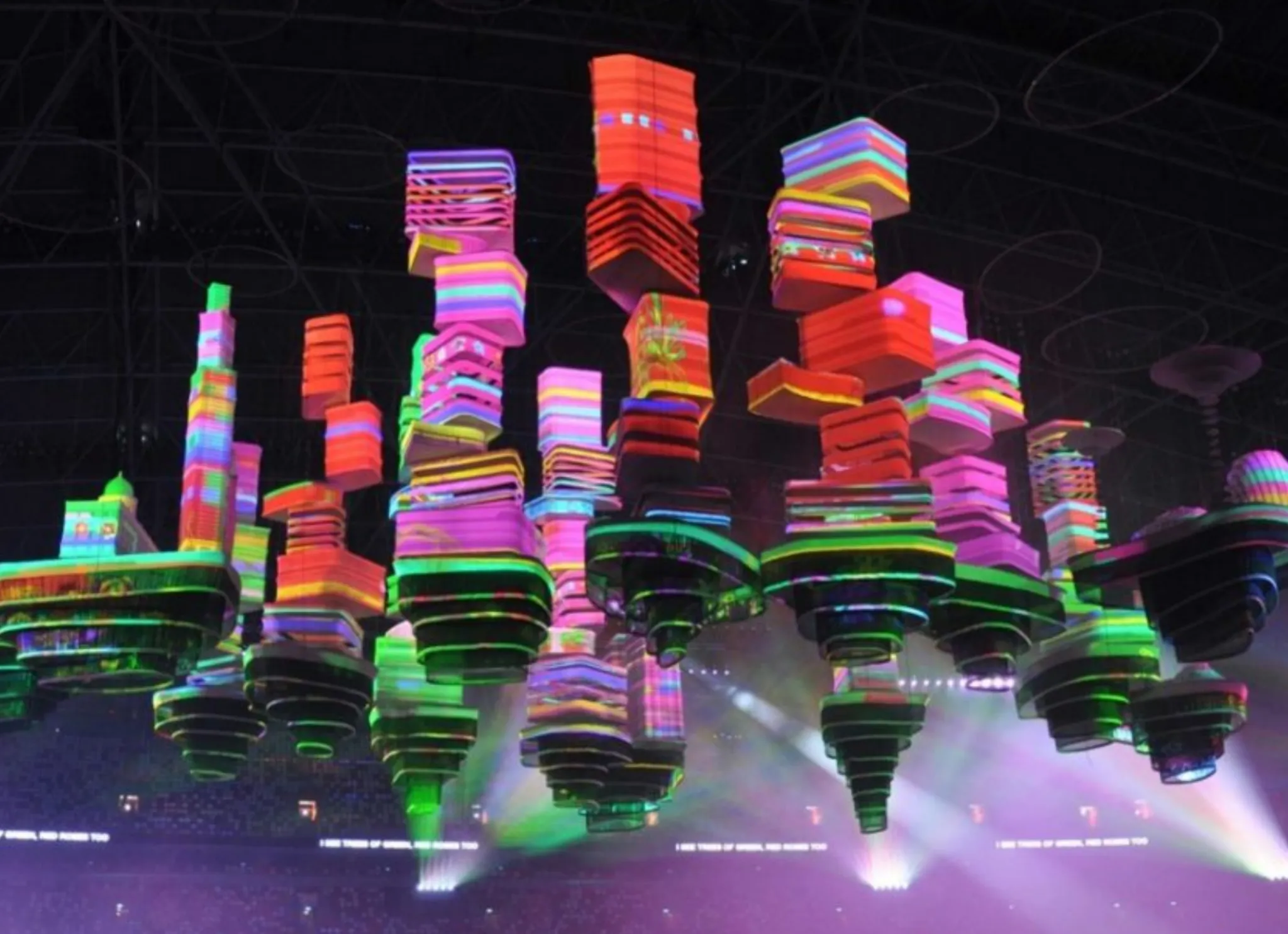 The flying city of Singapore National Day 2016: dozens of hanging building blocks, each projection-mapped in vivid colors.