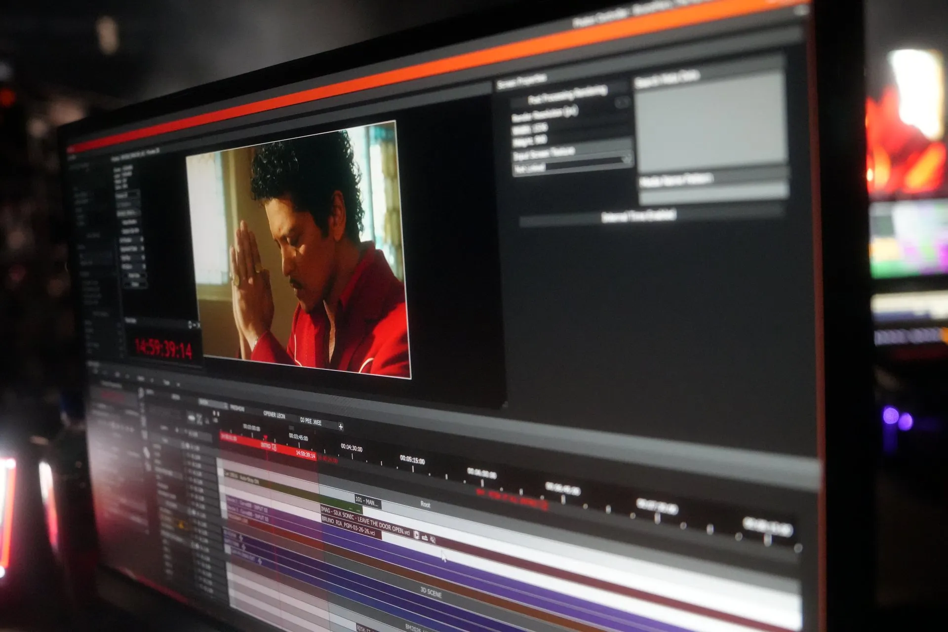 a monitor showing the show's Timeline in PHOTON, with an image of Bruno Mars in the preview